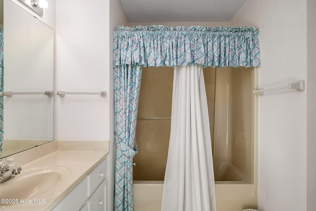 bathroom with vanity, a textured ceiling, and shower / bath combo