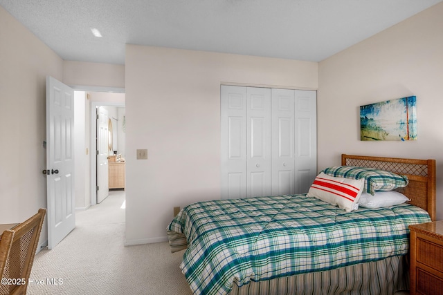 bedroom featuring light colored carpet and a closet