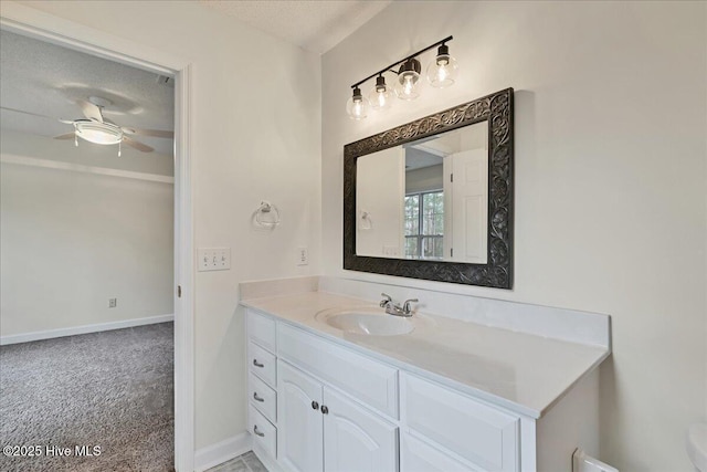 bathroom featuring vanity, a textured ceiling, and ceiling fan