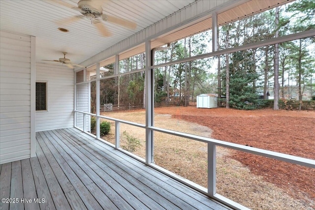 unfurnished sunroom with ceiling fan