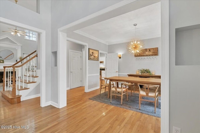 dining room featuring ornamental molding, hardwood / wood-style floors, and an inviting chandelier