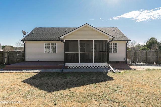 rear view of house with a yard, a sunroom, and a deck