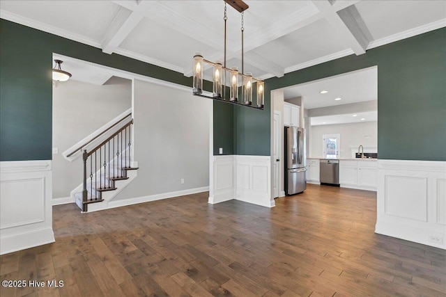 unfurnished dining area featuring dark hardwood / wood-style flooring, beam ceiling, an inviting chandelier, and coffered ceiling