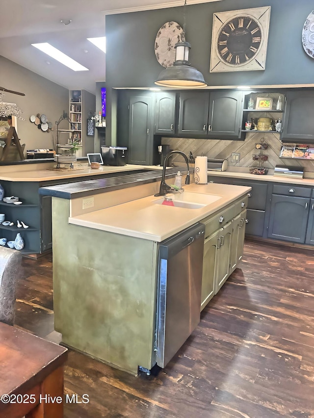 kitchen featuring pendant lighting, sink, a kitchen island, dark hardwood / wood-style flooring, and stainless steel dishwasher