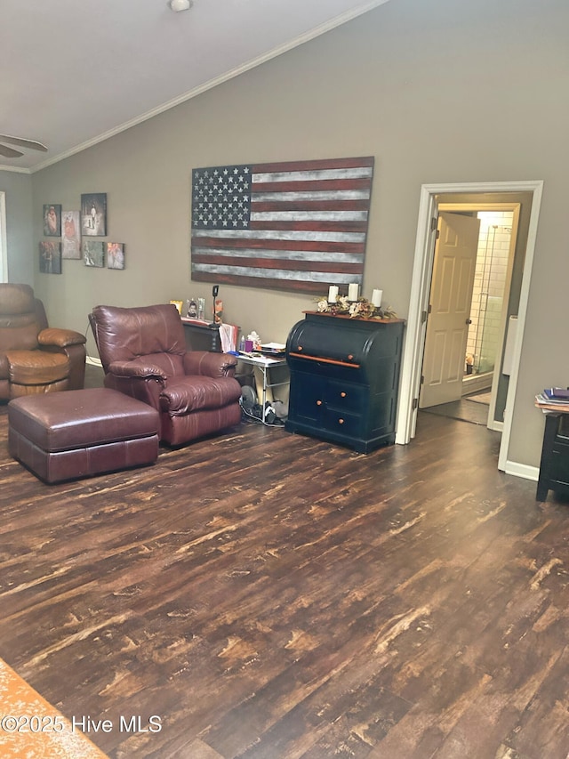 living room with ornamental molding, lofted ceiling, and dark hardwood / wood-style floors