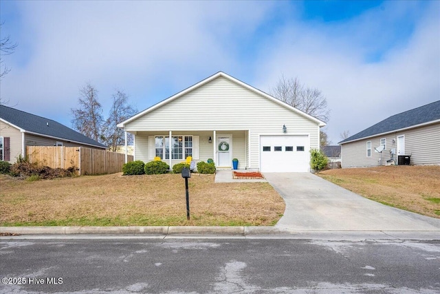 view of front of house featuring a porch, a garage, central AC unit, and a front yard