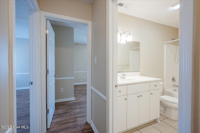 full bathroom with vanity, tile patterned floors, bathing tub / shower combination, and toilet