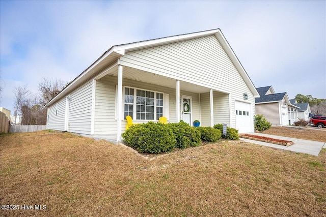 view of front of home with a garage, a front lawn, and covered porch