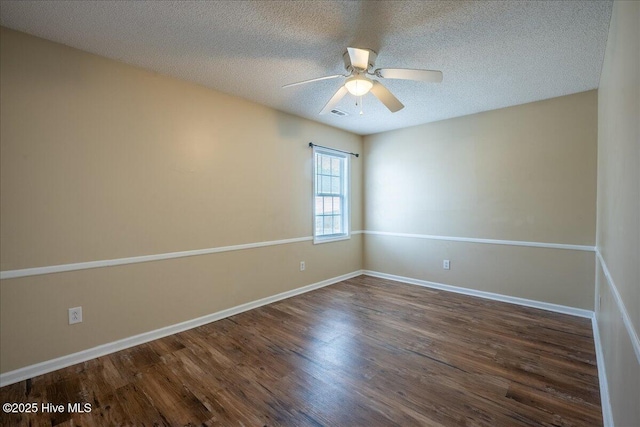 empty room with dark hardwood / wood-style flooring, ceiling fan, and a textured ceiling