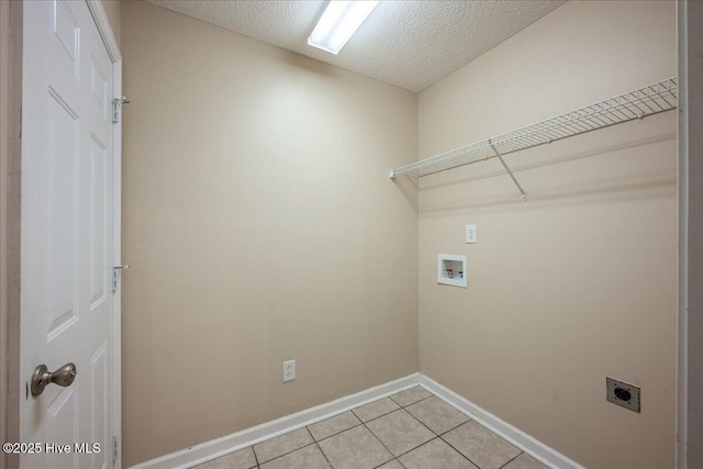 washroom with washer hookup, light tile patterned floors, hookup for an electric dryer, and a textured ceiling