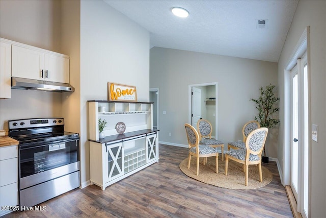 kitchen featuring white cabinetry, dark hardwood / wood-style flooring, butcher block counters, and stainless steel electric range oven