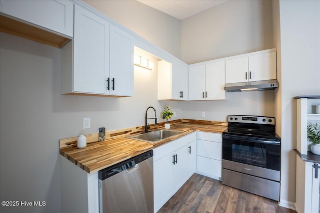 kitchen featuring white cabinetry, appliances with stainless steel finishes, sink, and butcher block countertops