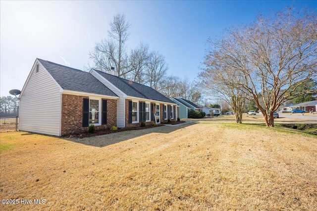 view of side of property with a yard