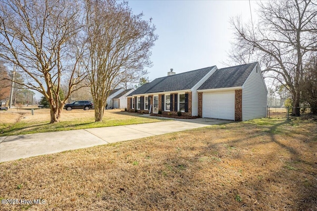 single story home featuring a garage and a front yard