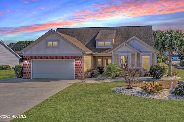 view of front of house featuring a garage and a lawn