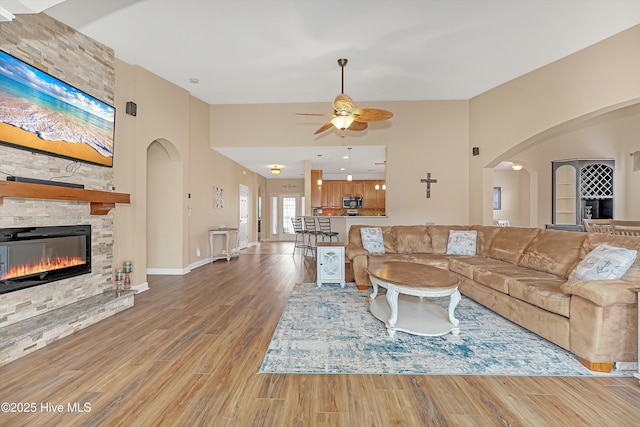 living room with ceiling fan, hardwood / wood-style floors, and a fireplace