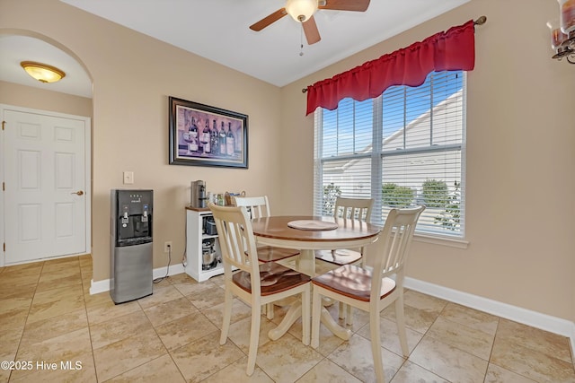 dining space with ceiling fan and tile patterned floors