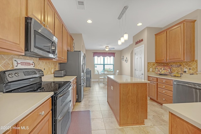 kitchen featuring appliances with stainless steel finishes, pendant lighting, tasteful backsplash, a center island, and light tile patterned floors