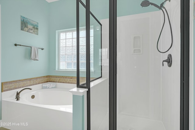 bathroom with shower with separate bathtub