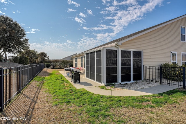 view of yard featuring a patio and a sunroom