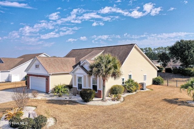 view of front facade with a garage, central AC, and a front lawn