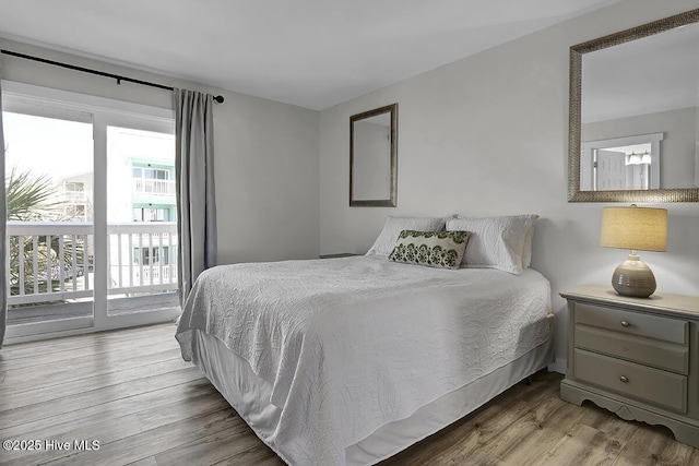 bedroom featuring light hardwood / wood-style floors and access to outside