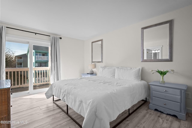 bedroom with access to exterior and light wood-type flooring