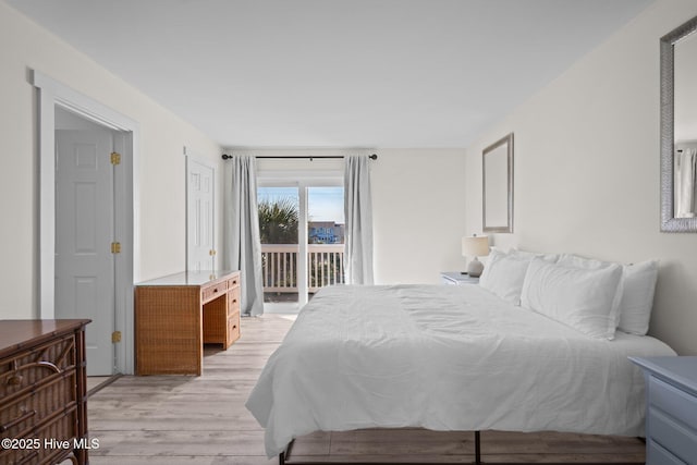 bedroom featuring light wood-type flooring and access to exterior