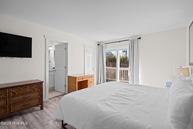 bedroom with access to outside, connected bathroom, and wood finished floors