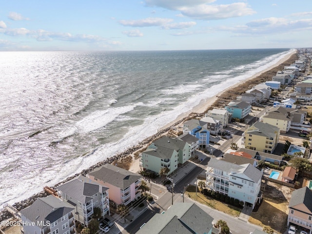 birds eye view of property with a beach view and a water view