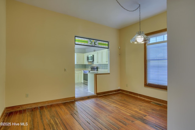 unfurnished room with light wood-type flooring