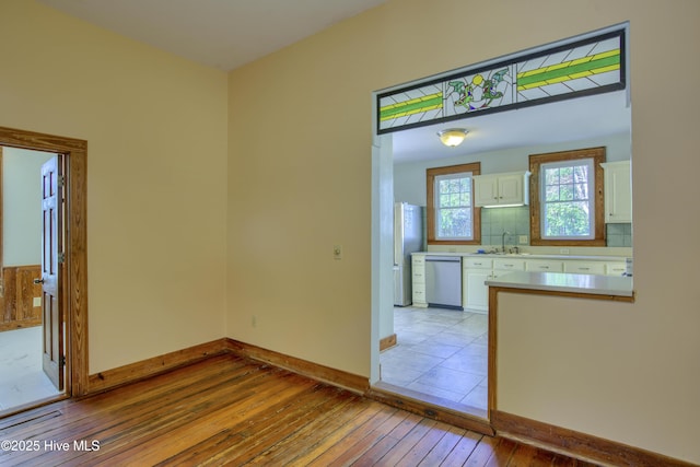 interior space featuring sink and light hardwood / wood-style flooring