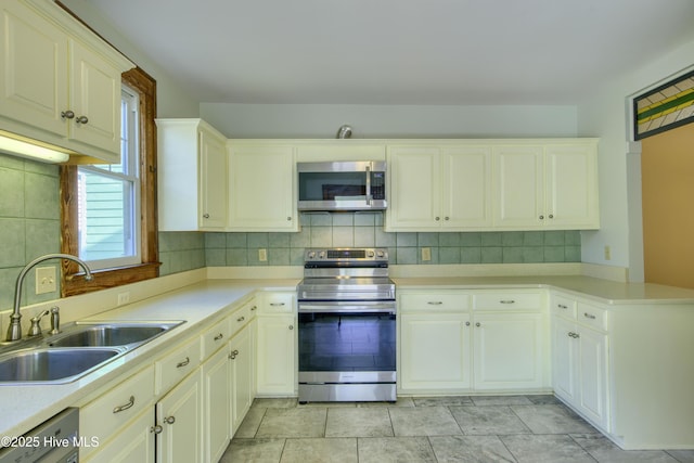 kitchen featuring sink, backsplash, and appliances with stainless steel finishes