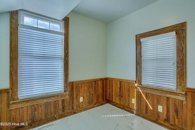 spare room with wooden walls