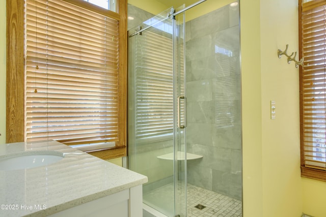 bathroom featuring vanity and a shower with shower door