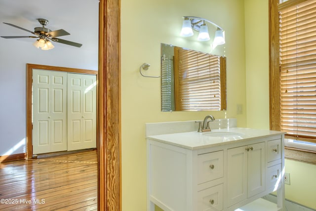 bathroom featuring vanity, wood-type flooring, and ceiling fan