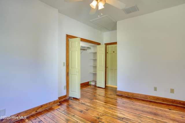 unfurnished bedroom featuring ceiling fan, wood-type flooring, and a closet