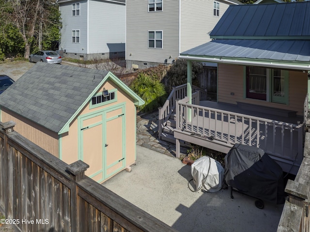 exterior space featuring a grill and a storage shed