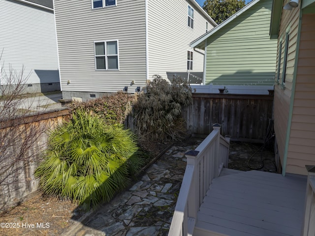 view of side of home with a deck