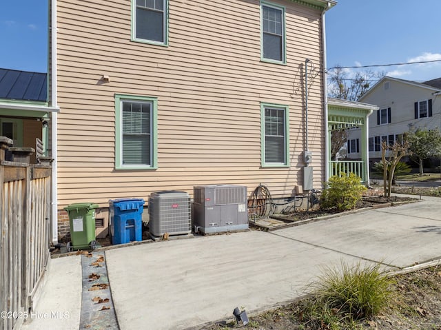 back of property with cooling unit and a patio area