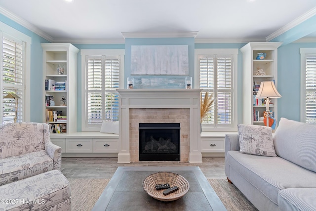 living room with ornamental molding and light hardwood / wood-style floors