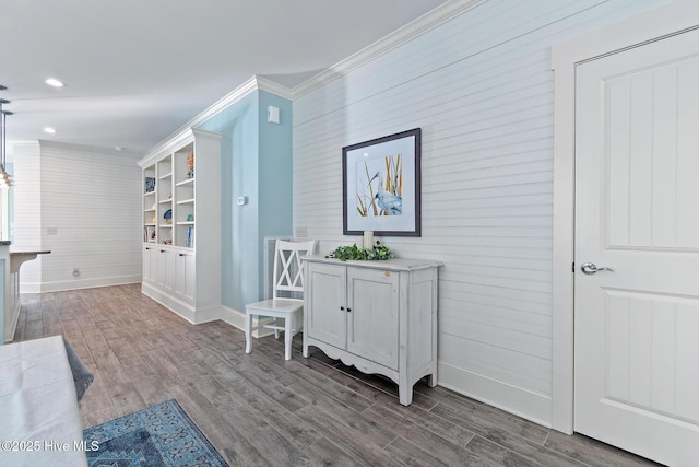 corridor with hardwood / wood-style flooring and crown molding