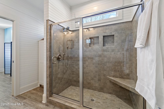 bathroom with hardwood / wood-style floors and a shower with shower door