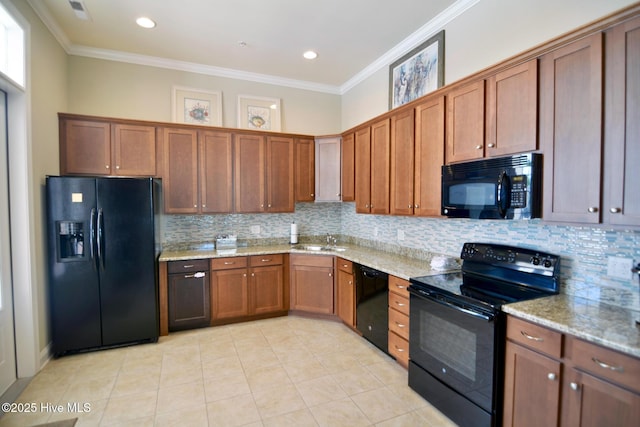 kitchen featuring tasteful backsplash, crown molding, light stone counters, and black appliances