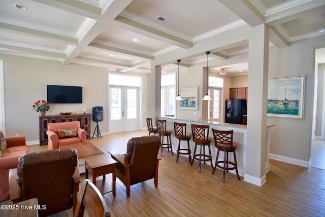 living room featuring crown molding, light hardwood / wood-style flooring, beam ceiling, coffered ceiling, and french doors