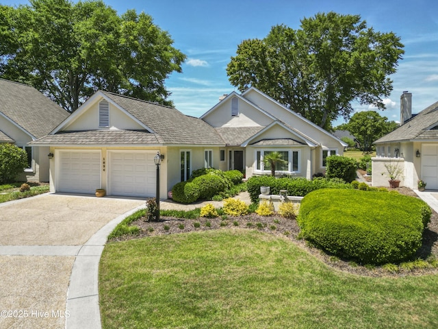view of front of house with a garage, driveway, stucco siding, and a front lawn