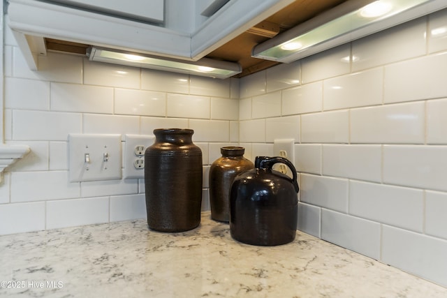 kitchen view of tasteful backsplash and light stone countertops