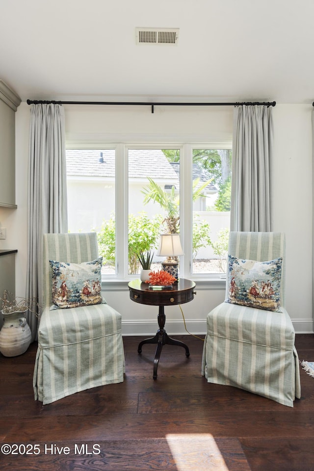sitting room with healthy amount of natural light, baseboards, and wood finished floors
