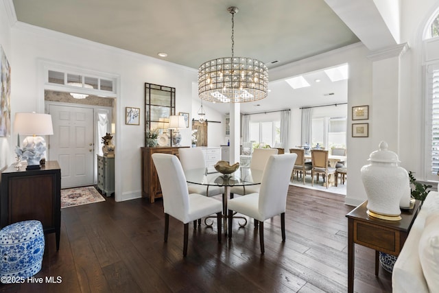 dining area featuring dark wood finished floors, crown molding, recessed lighting, a chandelier, and baseboards