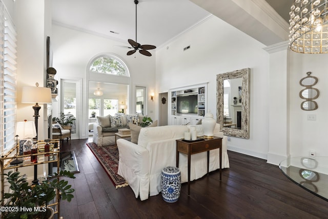 living room with a ceiling fan, hardwood / wood-style flooring, crown molding, and baseboards
